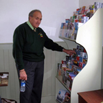 Dick Mazza in front of PP&D's brochure rack at the newly restored Colchester Schoolhouse